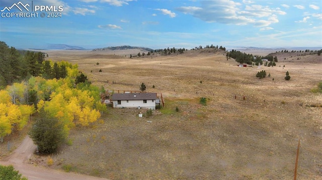 birds eye view of property with a mountain view and a rural view