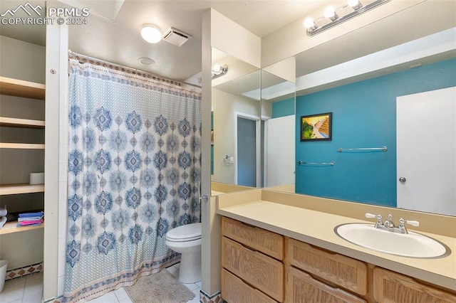 bathroom featuring tile patterned floors, vanity, and toilet