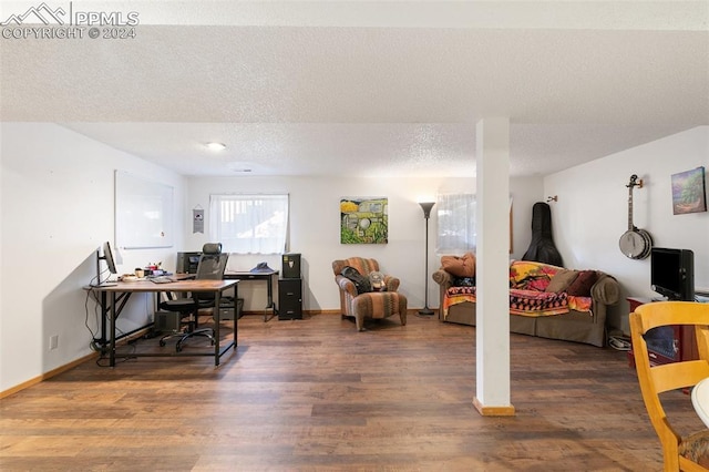 home office featuring a textured ceiling and dark hardwood / wood-style flooring