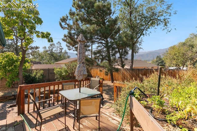 wooden deck featuring a mountain view