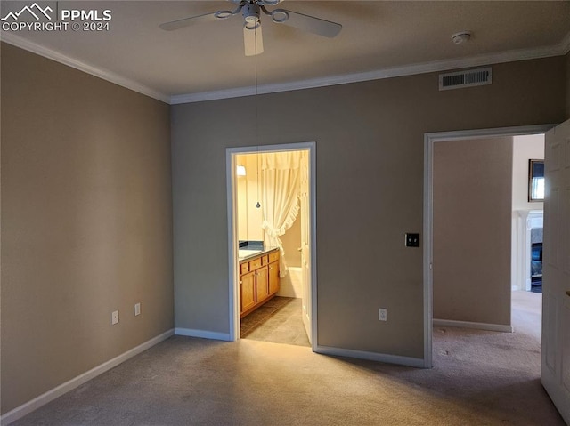 interior space featuring ornamental molding, light carpet, ceiling fan, and ensuite bathroom