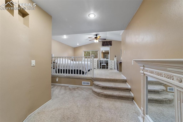 hall featuring carpet floors and lofted ceiling