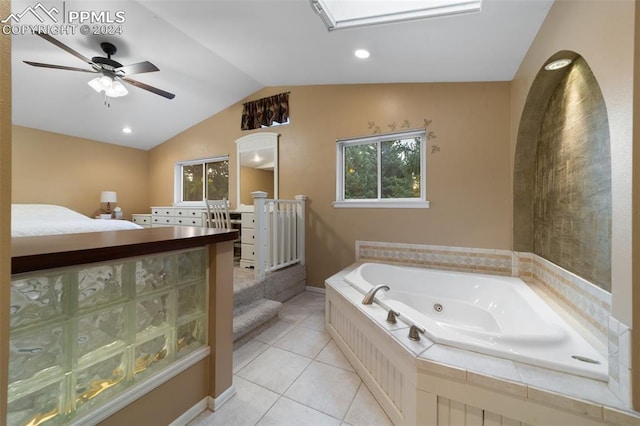 bathroom featuring ceiling fan, lofted ceiling, tile patterned floors, and a relaxing tiled tub