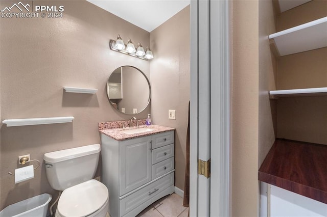 bathroom featuring vanity, toilet, and tile patterned floors