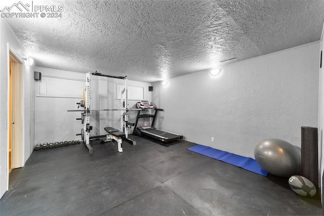 exercise area featuring a textured ceiling