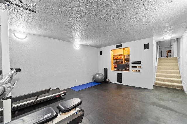 workout room with a textured ceiling