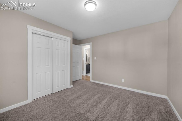 unfurnished bedroom with a closet and carpet