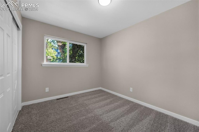 unfurnished bedroom with a closet and carpet flooring