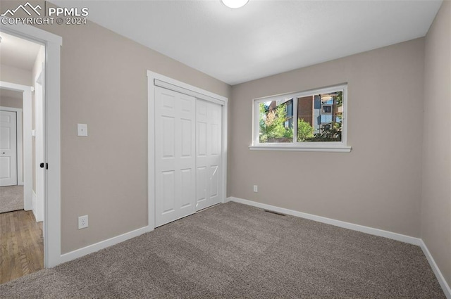 unfurnished bedroom featuring a closet and carpet flooring