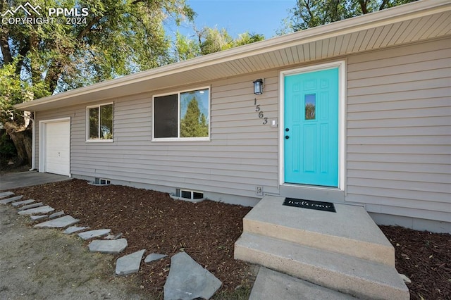 view of exterior entry featuring a garage