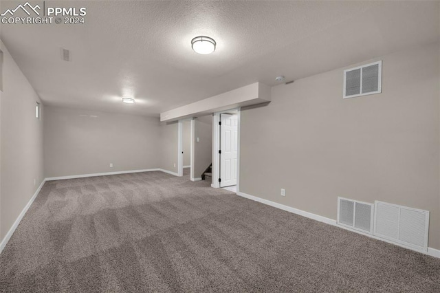 basement with a textured ceiling and carpet