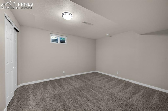 basement with carpet floors and a textured ceiling