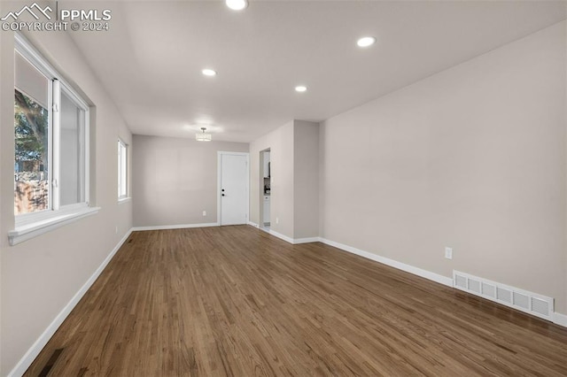 spare room with dark wood-type flooring