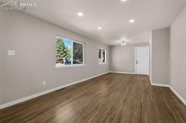 spare room featuring dark wood-type flooring