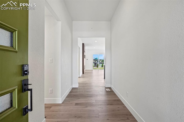 corridor featuring light hardwood / wood-style floors