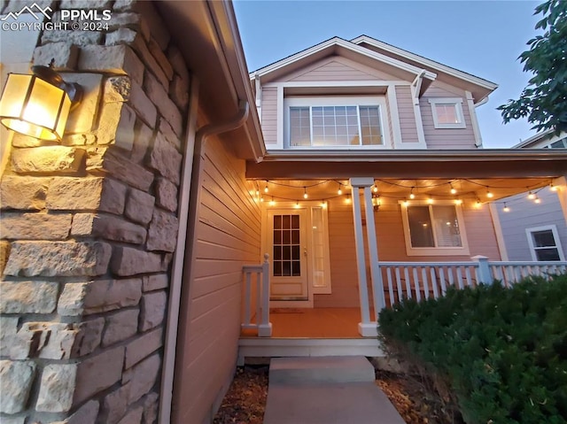 doorway to property featuring covered porch