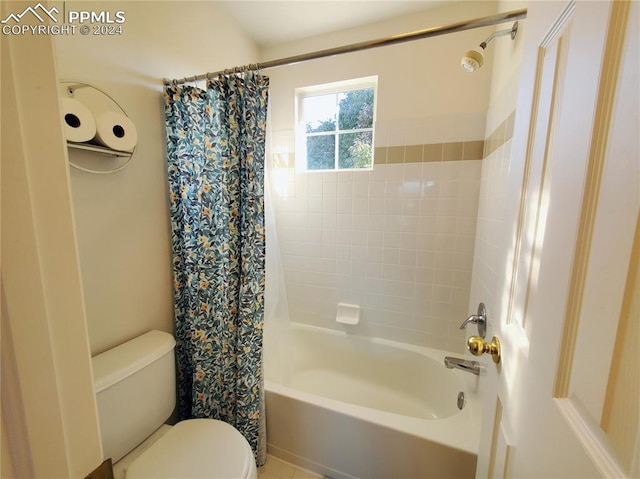 bathroom with shower / bath combination with curtain and toilet