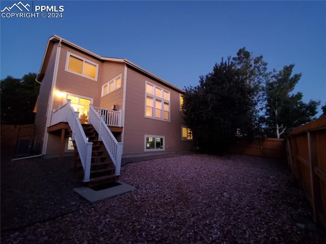 view of back house at dusk