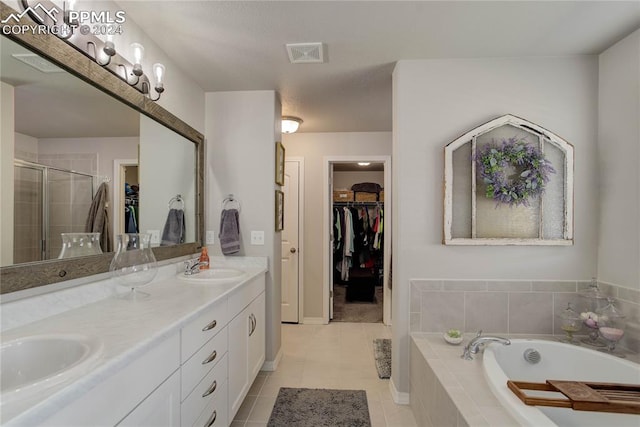 bathroom with tile patterned flooring, vanity, and plus walk in shower