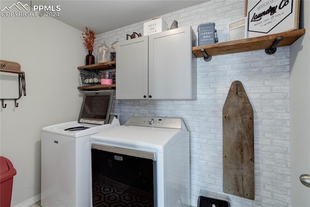 laundry room featuring cabinets and separate washer and dryer