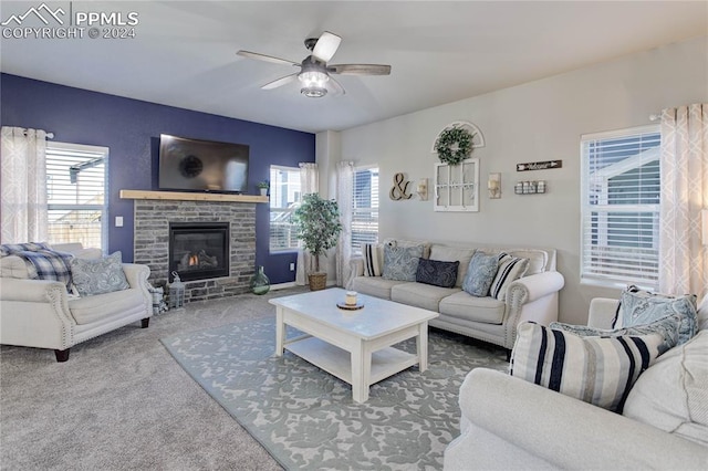 living room with carpet flooring, ceiling fan, a healthy amount of sunlight, and a fireplace