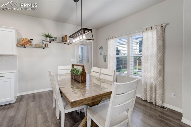 dining area with dark hardwood / wood-style floors