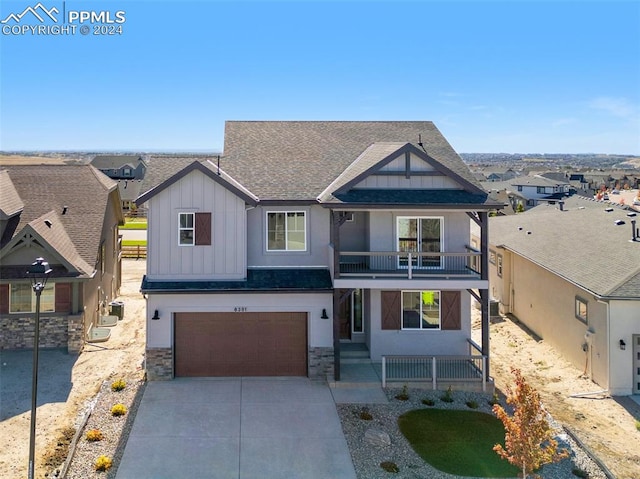 view of front of property featuring a garage and a balcony