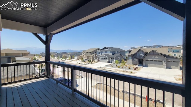 wooden deck featuring a mountain view and a garage