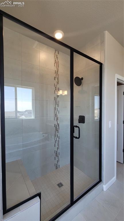 bathroom featuring a shower with door