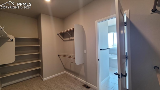 walk in closet featuring light tile patterned floors