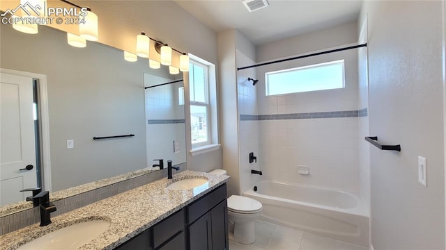 full bathroom featuring a healthy amount of sunlight, vanity, toilet, and tiled shower / bath combo