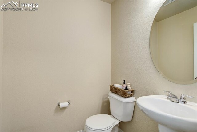 bathroom with toilet and sink