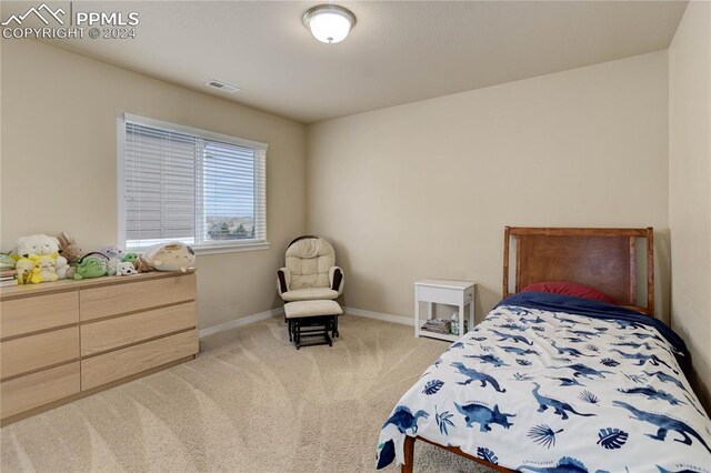 bedroom with light colored carpet