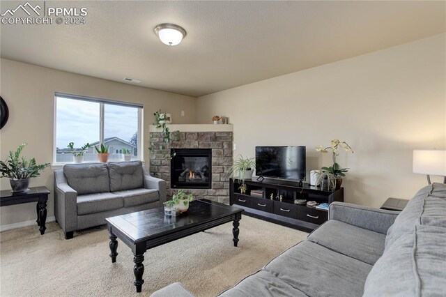 carpeted living room featuring a fireplace