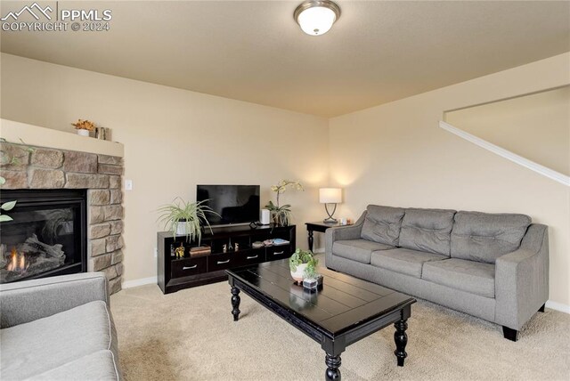 carpeted living room featuring a fireplace