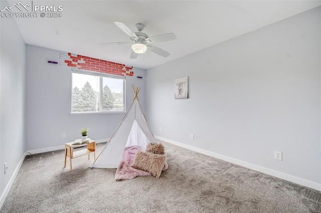 game room with carpet and ceiling fan