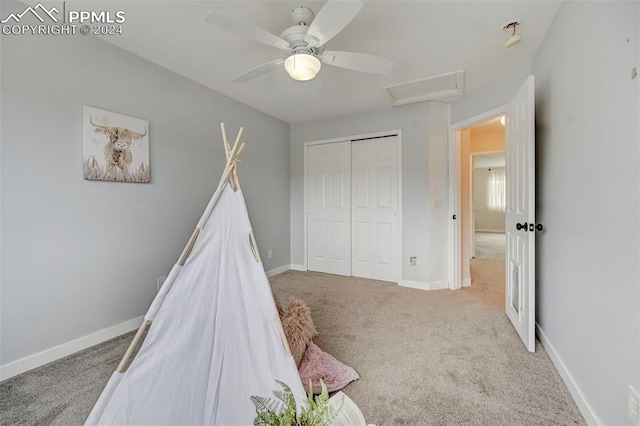 interior space with light carpet and ceiling fan