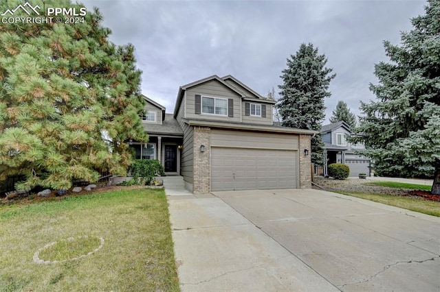 view of front of property featuring a front yard and a garage