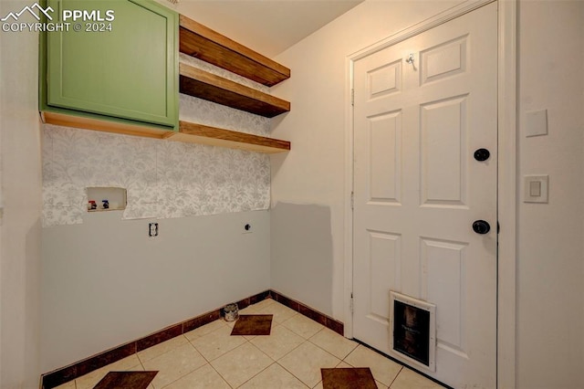 washroom with hookup for a washing machine, electric dryer hookup, cabinets, and light tile patterned flooring