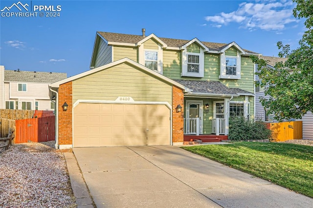 view of front of home with a garage and a front lawn