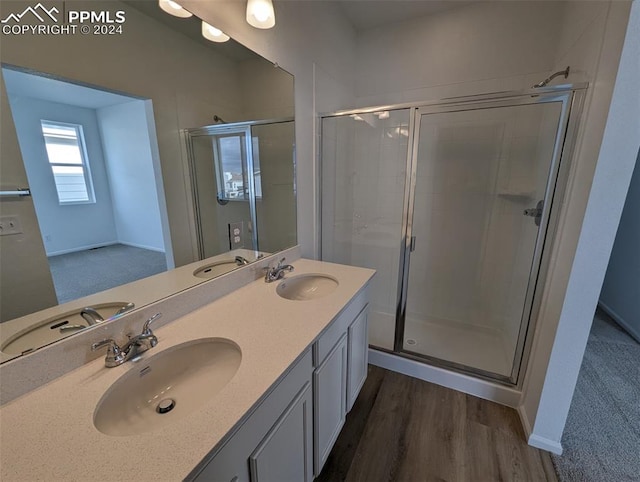 bathroom featuring vanity, an enclosed shower, and wood-type flooring