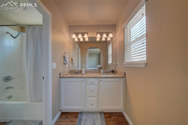 bathroom with vanity, hardwood / wood-style floors, and shower / tub combo with curtain