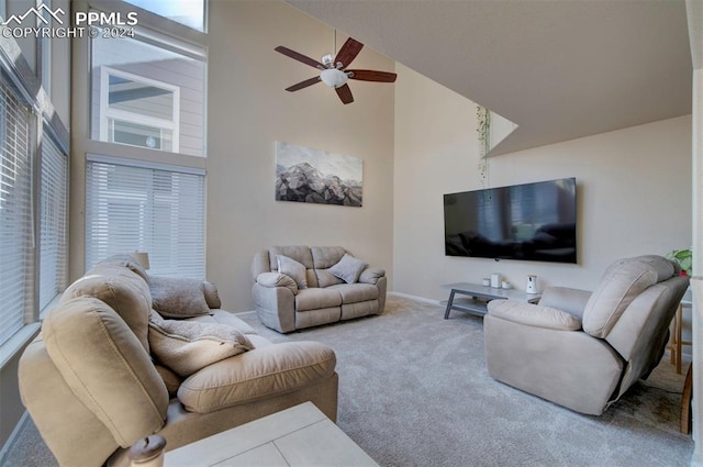 living room with ceiling fan, carpet, and high vaulted ceiling