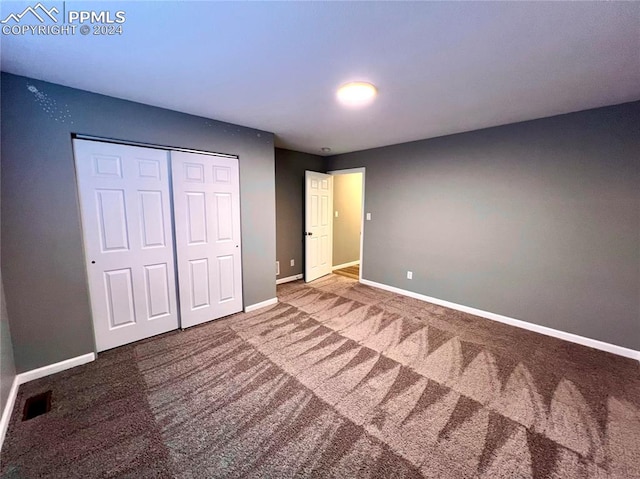 unfurnished bedroom featuring carpet floors and a closet