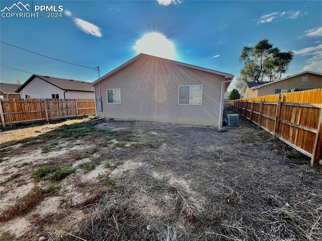 rear view of property featuring central air condition unit