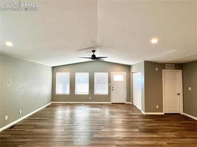 interior space featuring dark wood-type flooring, vaulted ceiling, and ceiling fan