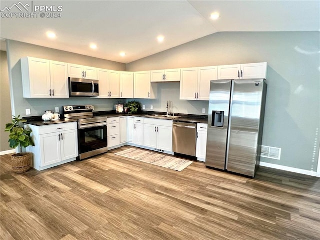 kitchen with light hardwood / wood-style floors, sink, stainless steel appliances, and white cabinets