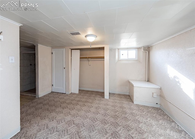 unfurnished bedroom featuring light carpet and a closet