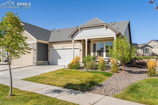 view of front of house with a front lawn and a garage