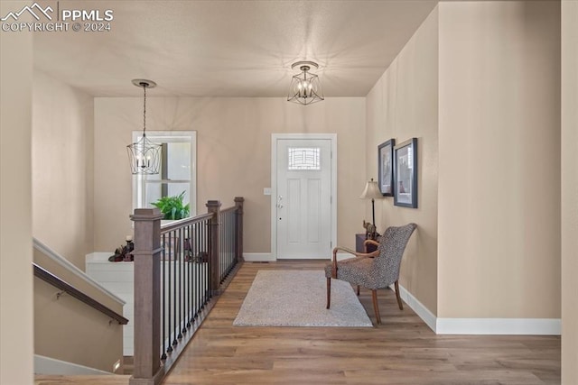 entrance foyer featuring light hardwood / wood-style floors and a chandelier